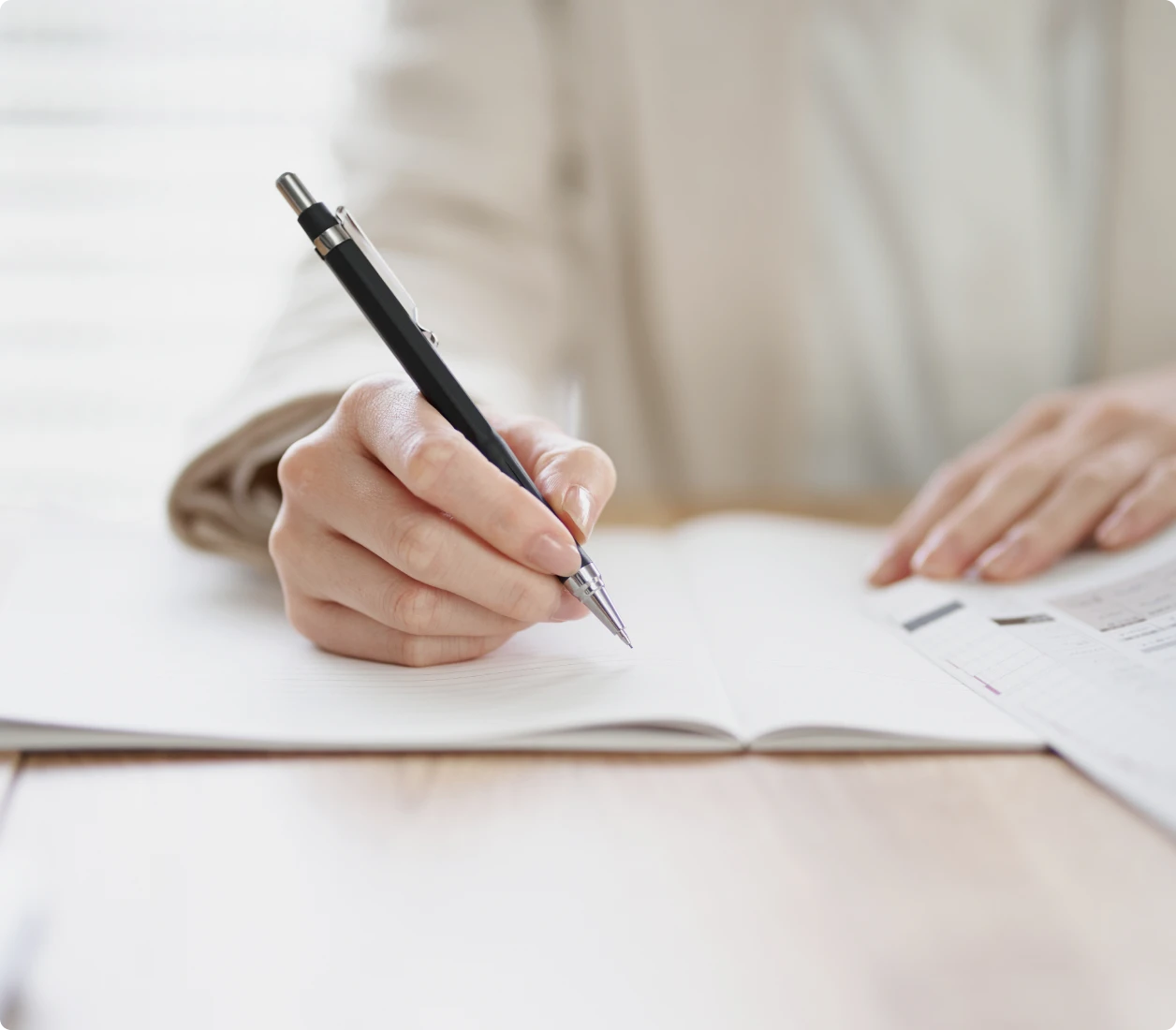 Person taking notes with pen